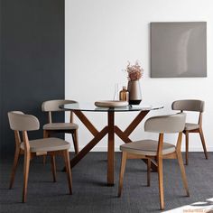 a glass table with four chairs around it