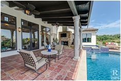 an outdoor living area next to a swimming pool