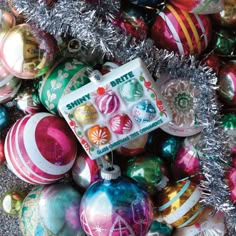 a pile of christmas ornaments with tinsel around them