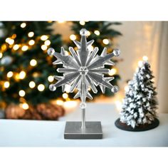 a snowflake on a table next to a christmas tree