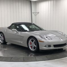 a silver sports car parked in a garage