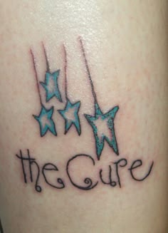 a small tattoo with stars and the word the cure on it