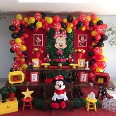 a mickey mouse birthday party with balloons and decorations