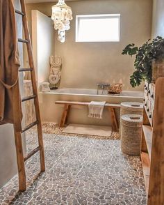 a bathroom with a ladder in the middle of it and a bathtub next to it