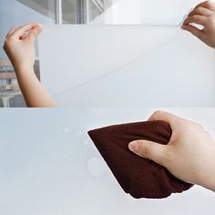 a hand holding a microfit cloth over a window sill to clean it