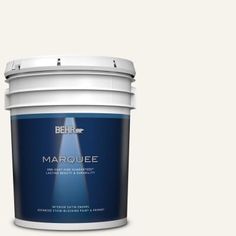 the behr color marquee paint is shown in an open bucket on a gray background