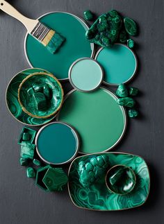 green and gold plates with paintbrushes on the top one being used as an art project