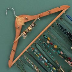 a pair of wooden clothes hangers filled with jewelry