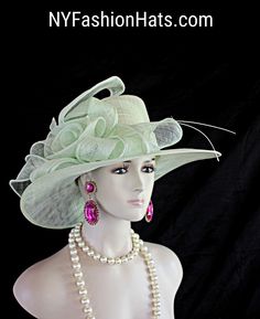 Women's Mint Green Sinamay Straw Large Abstract Brim Couture Designer Hat. This Beautiful Hat Is Embellished With A Decorative Large Sinamay Straw Bow. This Formal Statement Hat Wedding Headpiece Can Be Worn In Different Positions. This Elegant Soft Pastel Colored Hat Will Make A Fashion Statement. This ladies bespoke couture formal designer wedding fascinator hat is appropriate to wear for horse races, The Kentucky Derby, The Dubai World Cup, The Royal Ascot, The Melbourne Cup, Belmont Stakes, Summer Ceremony Hats And Headpieces, Summer Ceremony Costume Hats And Headpieces, Brimmed Top Hat For Wedding, Curved Brim Costume Hats And Headpieces For Summer Ceremonies, Brimmed Wedding Hats For Summer, Wide Brim Summer Wedding Headpiece, Fitted Summer Hats For Ceremonies, Summer Wedding Wide Brim Headpiece, Fitted Hats For Summer Ceremonies