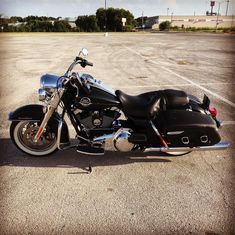 a black motorcycle parked in a parking lot