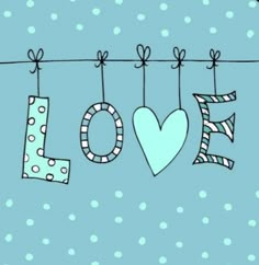 the word love is hanging on a clothes line with polka dot dots and heart shapes