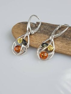 Amber + sterling silver. Multi colour amber. Silver 925 with hallmarks. All parts are sterling silver 925. When you by a pendant you also get a free gift - silver plated chain Earrings length 3.5 cm, pendant about 2.5 cm https://www.etsy.com/shop/AmberLithuania?ref=simple-shop-header-name&listing_id=780205095&section_id=27948198 Silver Baltic Amber Earrings, Amber Sterling Silver Dangle Earrings, Amber Pendant, Amber Earrings, Earrings Sterling Silver, Chain Earrings, Sterling Earrings, Gemstone Earrings, Earrings Handmade