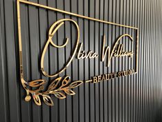 the logo for julia williams beauty studio is shown on a black and gold striped wall