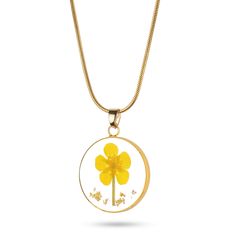 a necklace with a yellow flower in the center and two small white flowers on it