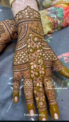 the hands and feet of a woman are decorated with henna designs on their palms