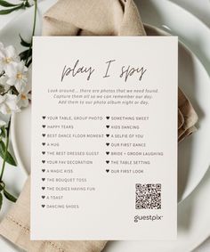 a white plate with a menu on it next to flowers and a napkin that says play i spy