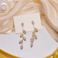 Add a touch of glamour to your wedding day with this romantic pair of earrings! The flawlessly faceted cubic zirconia stones capture the light in a dazzling array of sparkles, while the delicate links add fluidity and motion. The earrings are 14K gold / rhodium plated for a bright finish which enhances the intricate detailing. Length: 2.8" (approx. 7.2cm). Width: 0.6" (approx. 1.5cm). Weight: 7g. Available in Gold and Silver finishes. To make your choice select your preferred finish from the dro Wedding Sparkling Cubic Zirconia Diamond Earrings, Bridal Earrings With Rhinestones For Anniversary, Sparkling Crystal Diamond Earrings For Anniversary, Sparkling Cubic Zirconia Earrings For Wedding, Cubic Zirconia Bridal Earrings With Rhinestones For Anniversary, Sparkling Cubic Zirconia Wedding Earrings, Anniversary Bridal Earrings With Rhinestones And Cubic Zirconia, Anniversary Sparkling Crystal Diamond Earrings, Anniversary Bridal Earrings With Rhinestones In Cubic Zirconia