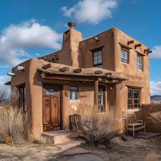 an adobe - style house sits in the desert