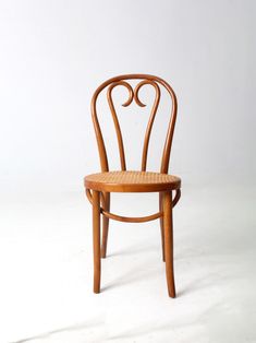 a wooden chair sitting on top of a white floor