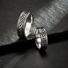 Sterling Silver Men's Celtic Wedding Ring Make a bold statement with this unique men's Sterling Silver Oxidized Celtic Knot Wedding Ring. Show off the intricate knot-work symbolizing your everlasting commitment and love. Enchant your beloved with this timeless design that speaks of devotion and eternity. Measurement: 8 mm wide Average Weight - 12.81g Available sizes 8 to 14 925 Sterling Silver Irish hallmarked in the Assay Office located in Dublin Castle. Featuring multiple trinity knot design a Hallmarked Jewelry For Wedding, Symbolic Wedding Rings With Decorative Band, Symbolic Wedding Rings With Round Band, Symbolic Round Band Wedding Rings, Symbolic Ring With Intricate Design For Promise, Symbolic Silver Couple Rings For Wedding, Mens Irish Wedding Bands, Celtic Knot Ring Mens, Mens Celtic Wedding Bands