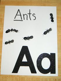 an ant's ad is displayed on a piece of paper with black ants flying around it