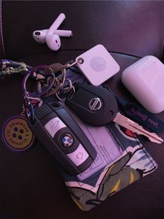 keys, car keys, and other personal items are laid out on a coach seat