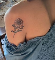 a woman with a sunflower tattoo on her shoulder