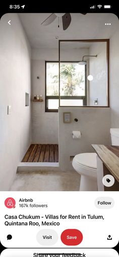 a bathroom with white walls and wood floors