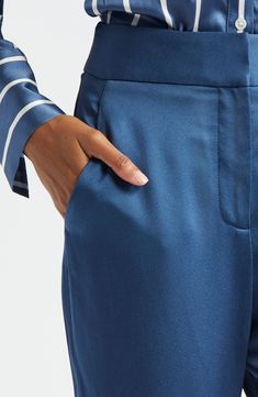 Widened hems and a cleanly styled front lend a leg-lengthening aesthetic to these lustrous satin pants that move from desk to dinner with elegant ease. 34 1/2" inseam; 24" leg opening; 12 1/2" front rise; 16 1/2" back rise (size 8) Zip fly with hook-and-bar closure Front slant pockets; back welt pockets Lined 72% acetate, 28% polyester Dry clean Made in the USA of imported fabric Satin Wide Leg Pants, Satin Pants, Veronica Beard, Blue Stone, Welt Pockets, Welt Pocket, Leg Pants, Wide Leg Pants, Wide Leg