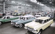 old cars are parked in an assembly line