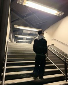 a person standing on some stairs with their back to the camera and looking at something