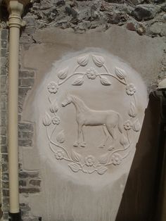 a white horse carved into the side of a building