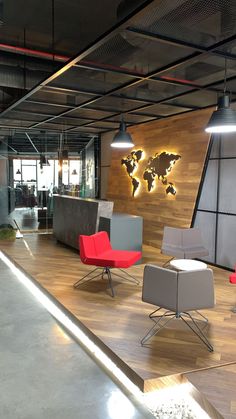 an office with chairs, desks and a world map on the wall