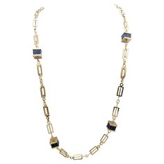 Contemporary elongated gold station necklace with natural lapis lazuli stones throughout. Long and luxurious, this modern necklace is a unique and fashionable piece you will wear again and again. This eye-catching necklace features a polished 14 karat yellow gold 37" long rectangular link chain. Throughout the necklace are 7 stations of natural square cut lapis lazuli, each varying slightly in their bold blue hues and natural striations, creating a truly one of a kind piece. The lengthy single s Luxury Gold Necklace With Lapis Lazuli, Luxury Single Strand Lapis Lazuli Necklace, Luxury Statement Necklace With Lapis Lazuli, Elegant Hand-strung Lapis Lazuli Necklaces, Luxury Statement Lapis Lazuli Necklace, Lapis Lazuli Stone, Square Cut, Station Necklace, Modern Necklaces