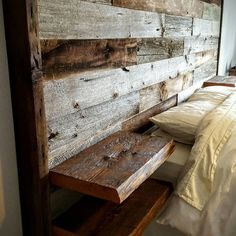 a bed sitting next to a wooden head board