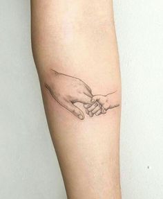 two hands touching each other on the left side of the arm, with one hand holding the other's hand