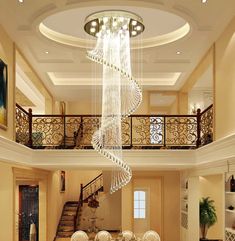 an elegant dining room with chandelier and white table set for four people in the center