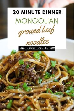 a white bowl filled with noodles and meat on top of a wooden table next to a hand holding a fork