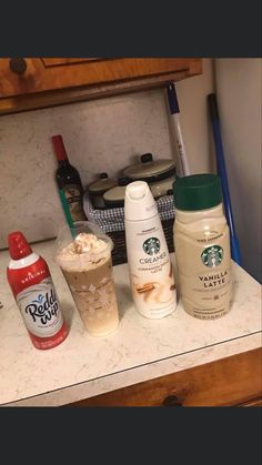 there are many different types of drinks on the counter in this kitchen, including iced coffee and whipped cream