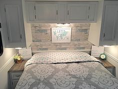 a bed in a room with wooden head board and lights on the wall above it