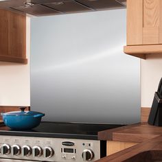 a stove top oven sitting inside of a kitchen next to wooden cabinets and counter tops