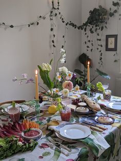 the table is set with flowers and candles