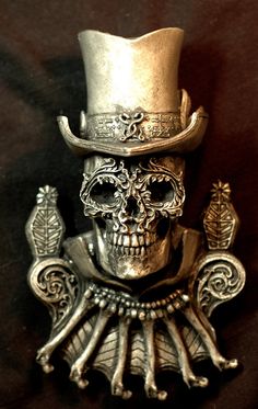 a skull wearing a top hat and holding two birds