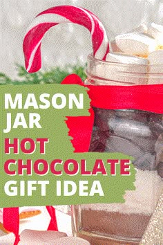 mason jar filled with hot chocolate and marshmallows for holiday gifts in front of candy canes