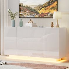 a living room scene with focus on the sideboard and painting above it's door