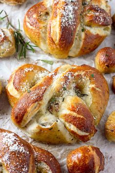 some bread rolls with cheese and herbs on top