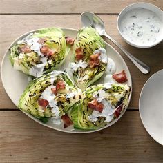 a white plate topped with brussel sprouts covered in bacon and ranch