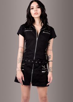 Three cheers for this black mini dress, because dressed in edgy style like this, life doesn’t get any better! This little black dress closes with a front zipper and is accessorized with rad buckles and studded details. Pretty corset lacing in the back adds to the edgy style of the dress as well as to an adjustable fit. Available in sizes XS, S, M, L, XL, XXL and XXXL. This rad dress gives others every reason to celebrate your wickedly awesome look! Measurements SIZE CHART DRESSES XS S M L XL XXL Black Goth Dress, Wednesday Dress, Shaggy Jacket, Black Lace Choker, Punk Dress, Emo Dresses, Faux Leather Biker Jacket, Black Goth, Goth Dress