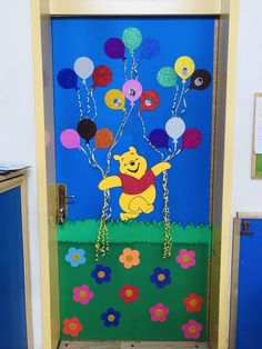 a door decorated with pooh and balloons