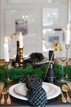 the table is set with candles, napkins and other holiday decor on top of it